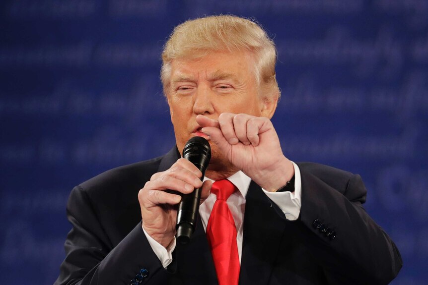Donald Trump gestures with his fingers while speaking in the second presidential debate in St Louis.
