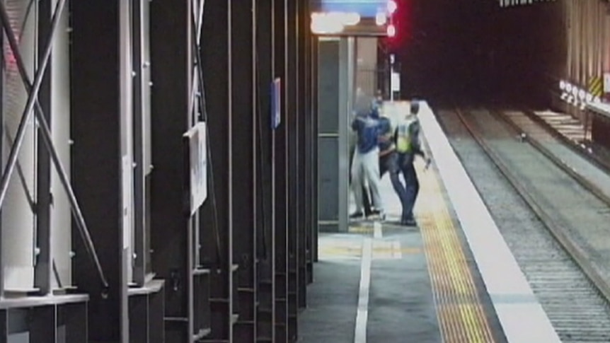 Protective Service Officers struggle with teenage fare evader on railway platform