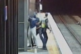 Protective Service Officers struggle with teenage fare evader on railway platform