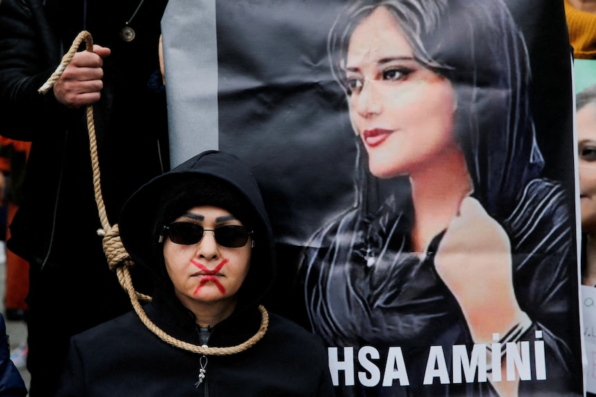A woman takes part in a protest against the Islamic regime of Iran following the death of Mahsa Amini.