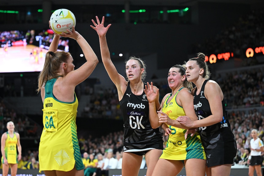 Steph Wood puts a shot up as Sophie Garbin is sandwiched by Silver Ferns defenders