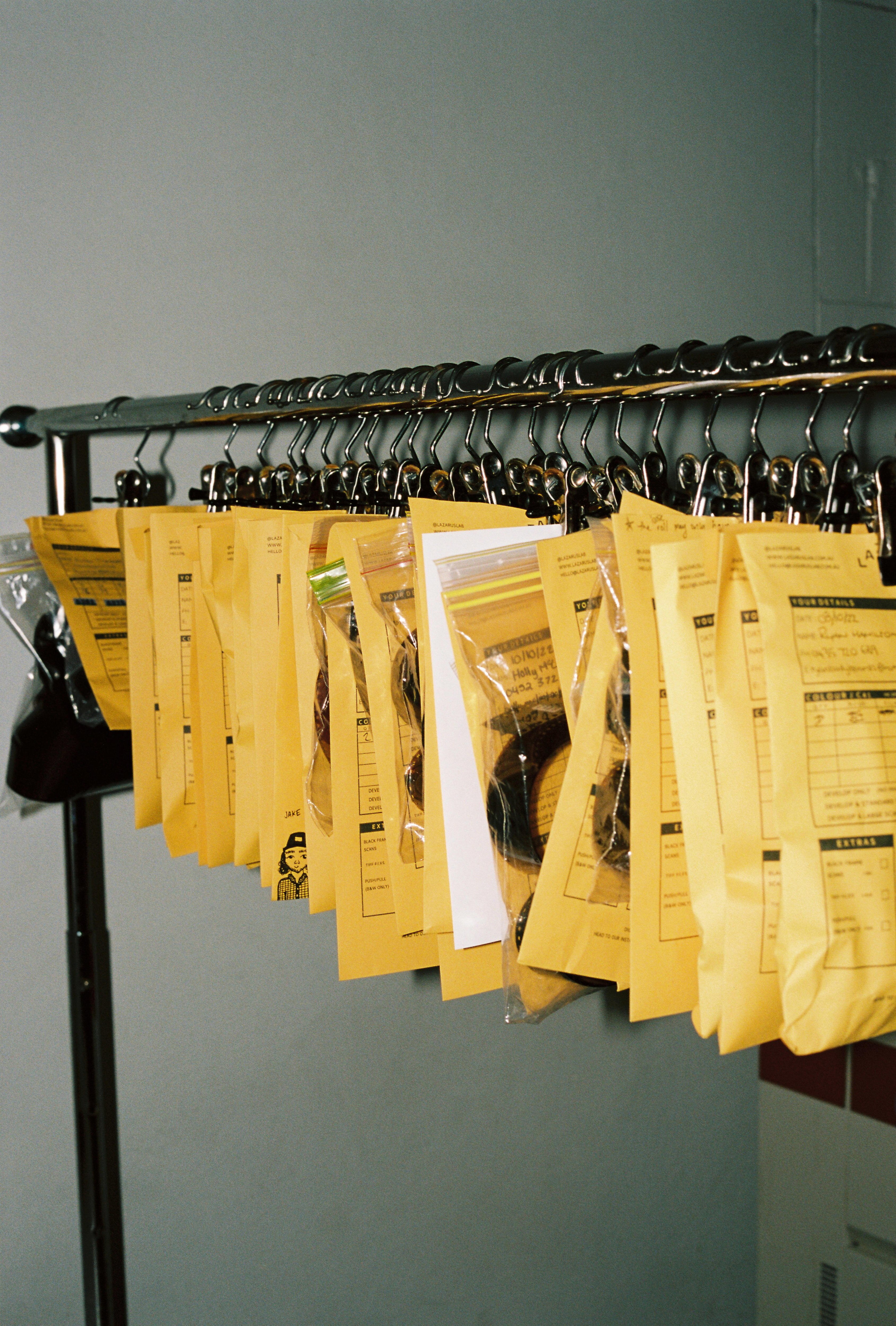 Packages of film lined up hanging from a coat rack