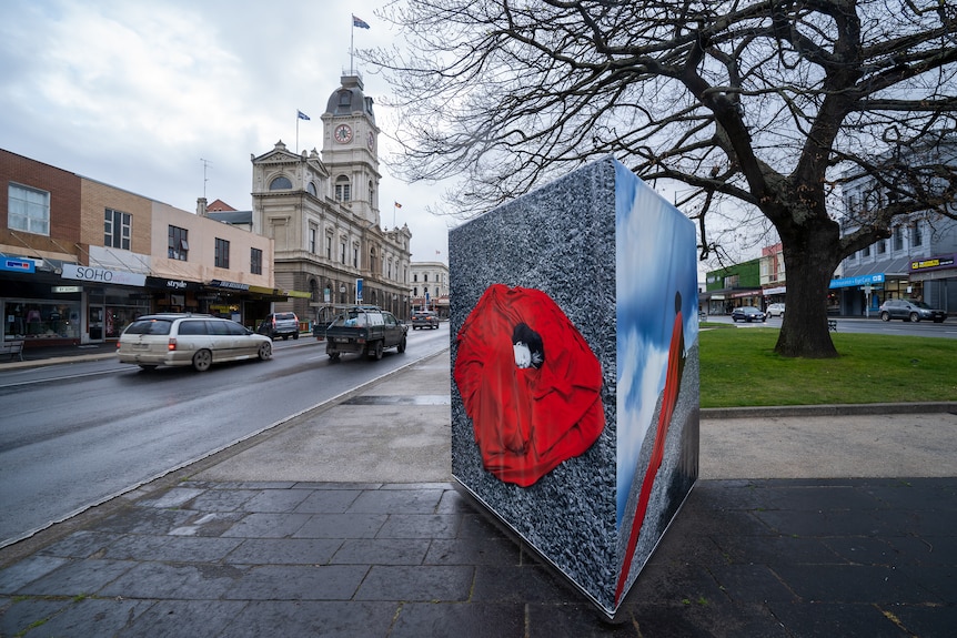 main street of ballarat with a large photos exhibited on a triangular frame on the median stip.