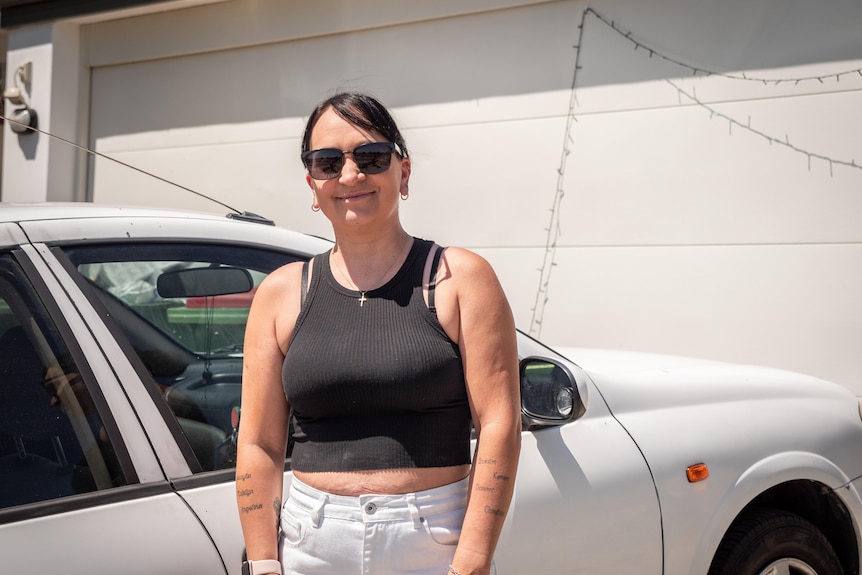 Jeanie Barbagiovanni with the car she was able to buy.