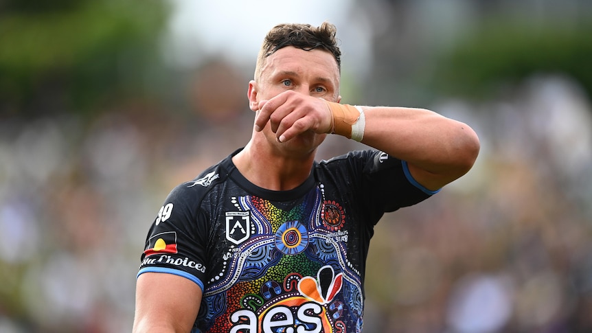 Jack Wighton wipes his nose while standing on the field in the NRL Indigenous All Stars game.