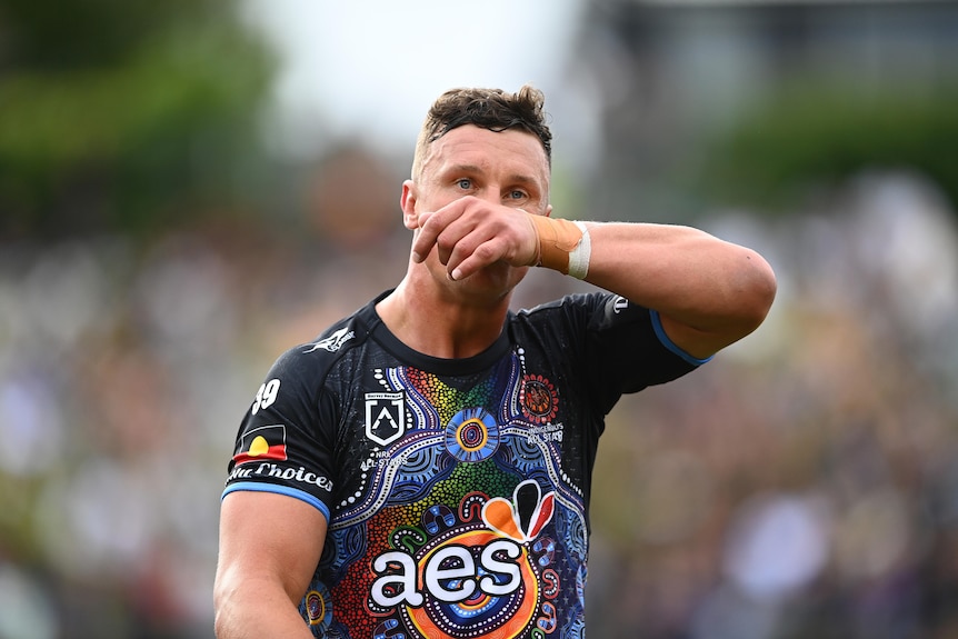 Jack Wighton wipes his nose while standing on the field in the NRL Indigenous All Stars game.