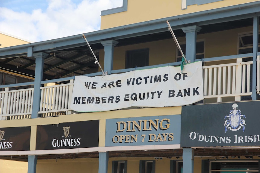 A sign on the front of a pub saying we are victims of members equity bank