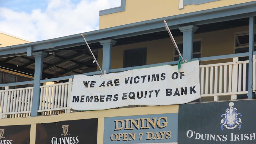 A sign on the front of a pub saying we are victims of members equity bank