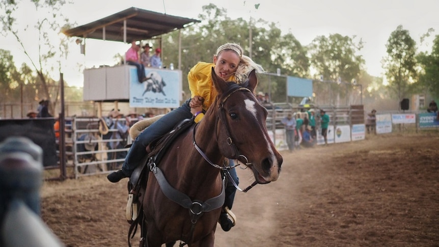 Trick rider Kirby McQueen pictured during her white knuckle performance at the Fitzroy Crossing Campdraft and Rodeo.