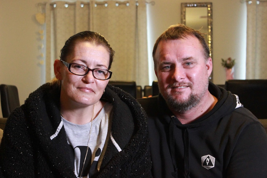 Rachel and Andrew Hayden sitting in the living area of their home.