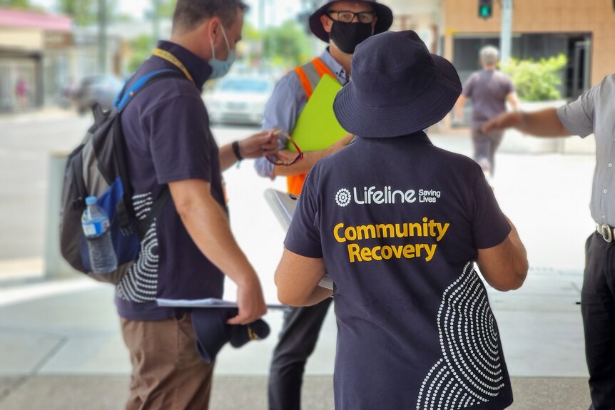 Lifeline community recovery written on the back of a T-shirt of a person in the street.