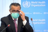 Tedros Adhanom Ghebreyesus wearing a surgical mask while appearing at a press conference.