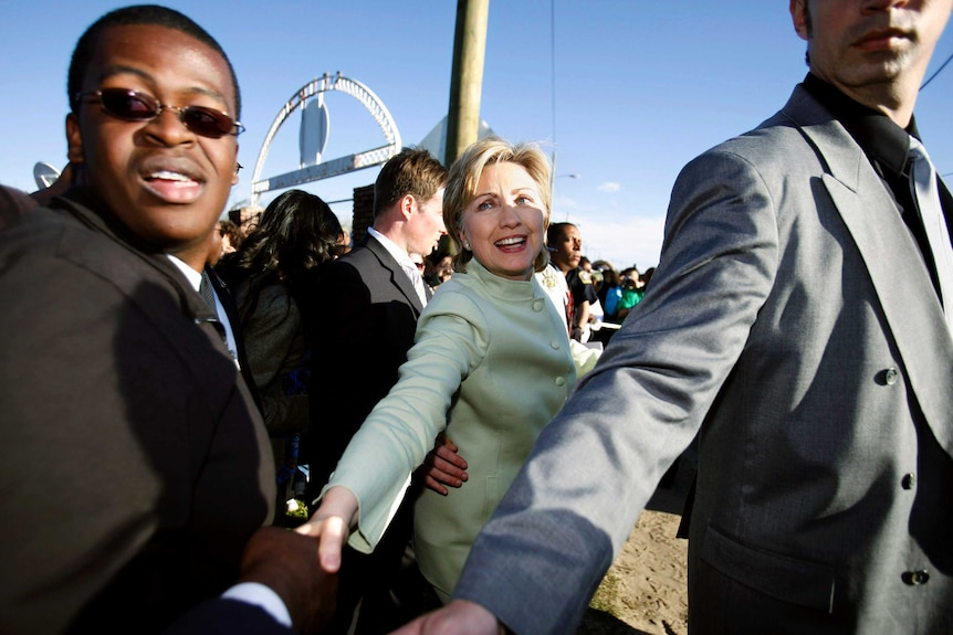 Hillary Clinton surrounded by bodyguards