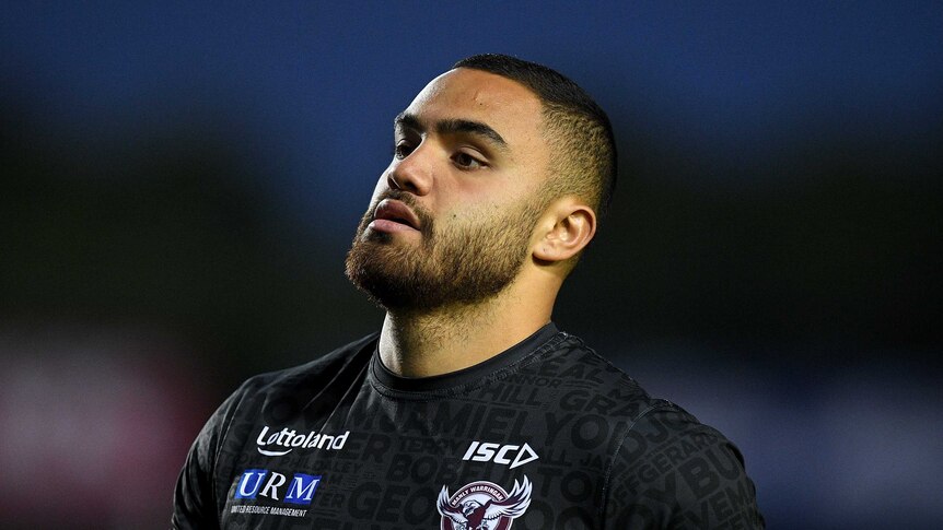 A Manly player stands during the warm-up before an NRL game.