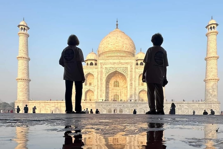 The silhouette of two ladies in front of the Taj Mahal 