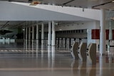 Unattended check-in desks and self check-in machines in a dark airport terminal