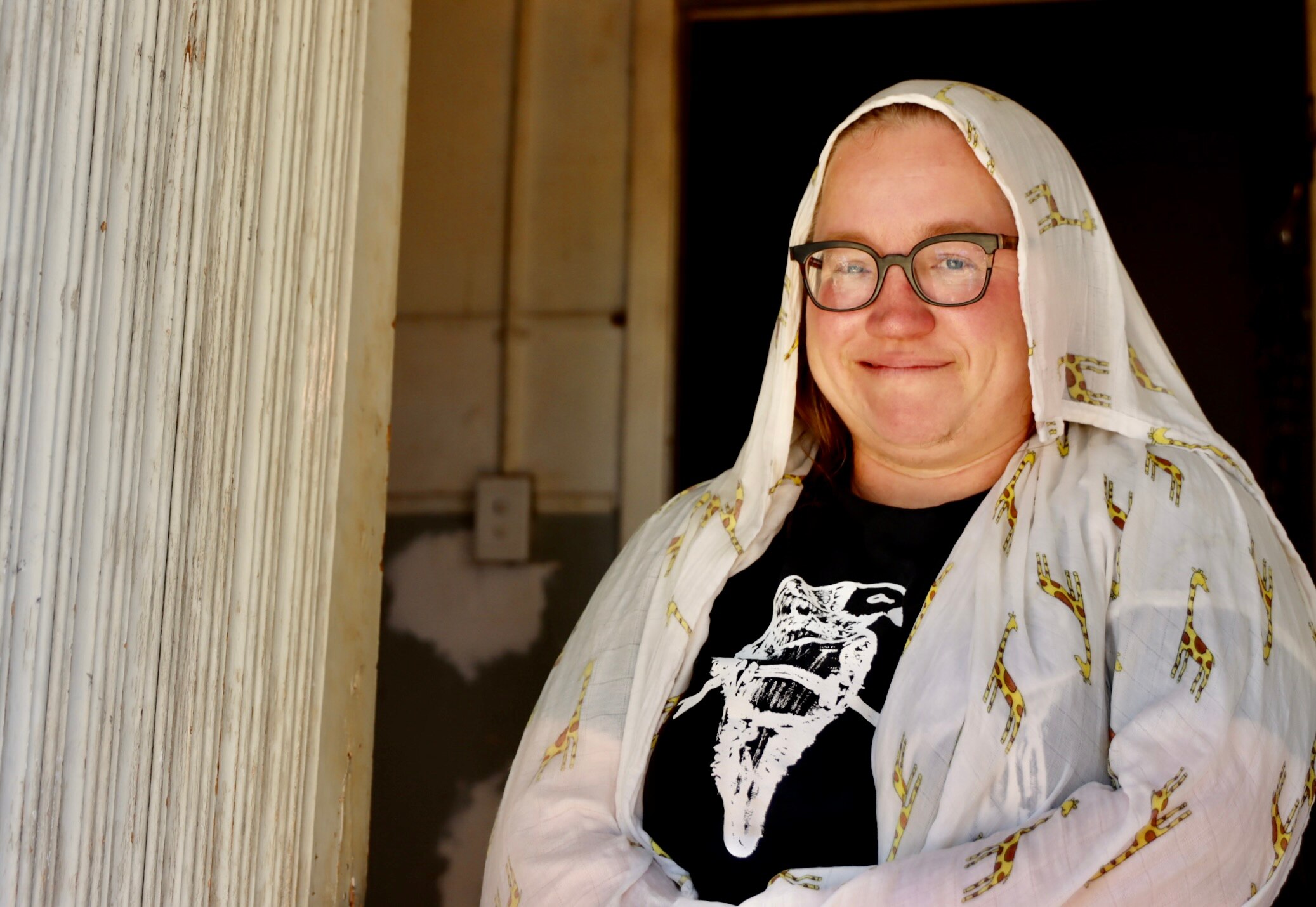 woman with glasses and white wet cloth on her head