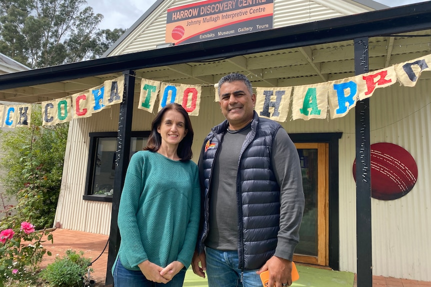 A white woman and indigenous man stand out the front of a building welcoming Black Cockatoo to Harrow