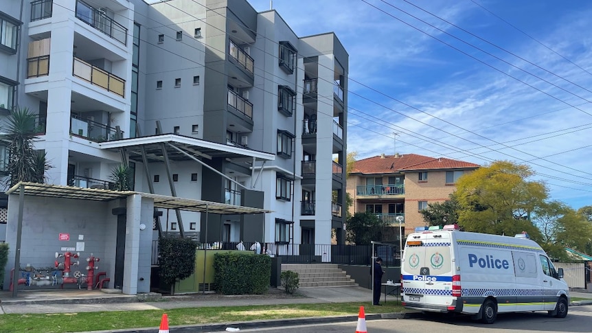 A police van outside an apartment block