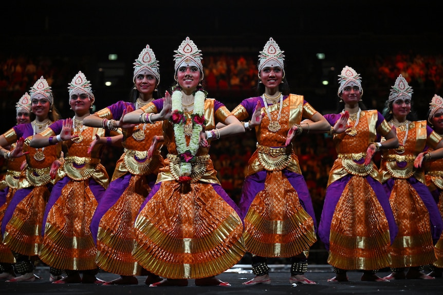 Dancers in colourful outfits on a stage