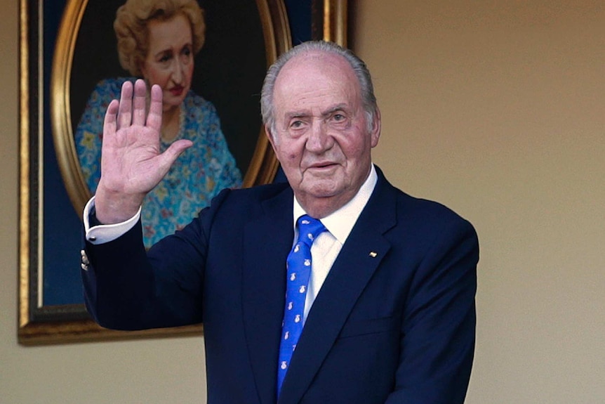 Spain's former King Juan Carlos waves during a bullfight at the bullring in Madrid.