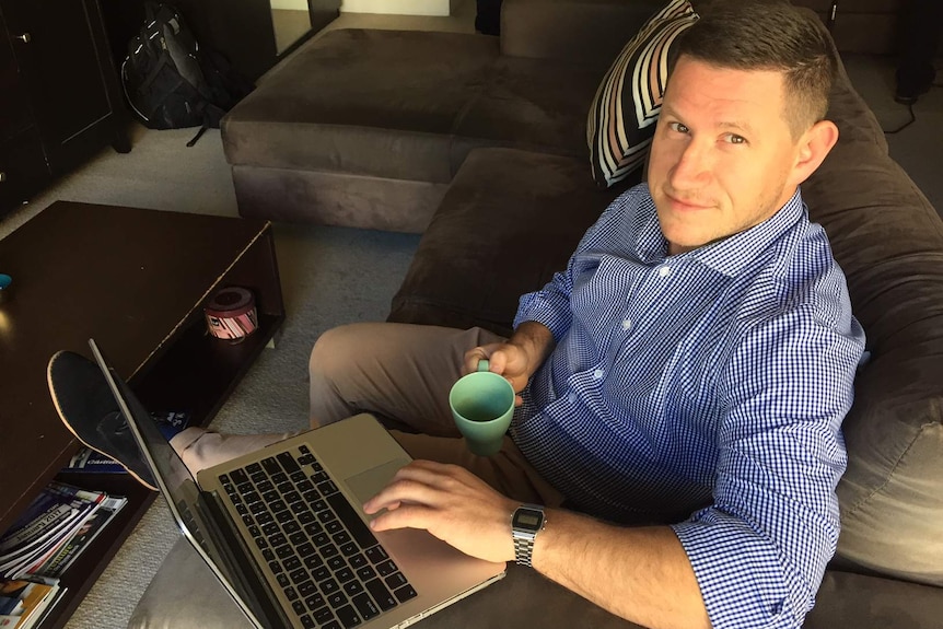 Rent vestor, Rob Cooper, sitting in his rented Sydney home with a cup of tea and working on his laptop