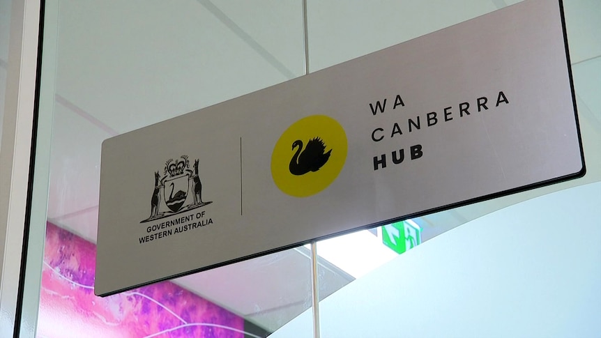 A sign affixed to a ceiling with the WA crest and the words "WA Canberra Hub"