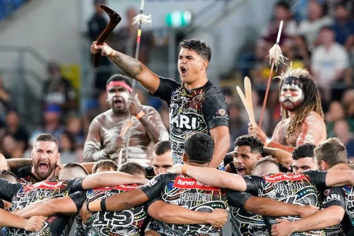 A photo of indigenous football players in indigenous jerseys.