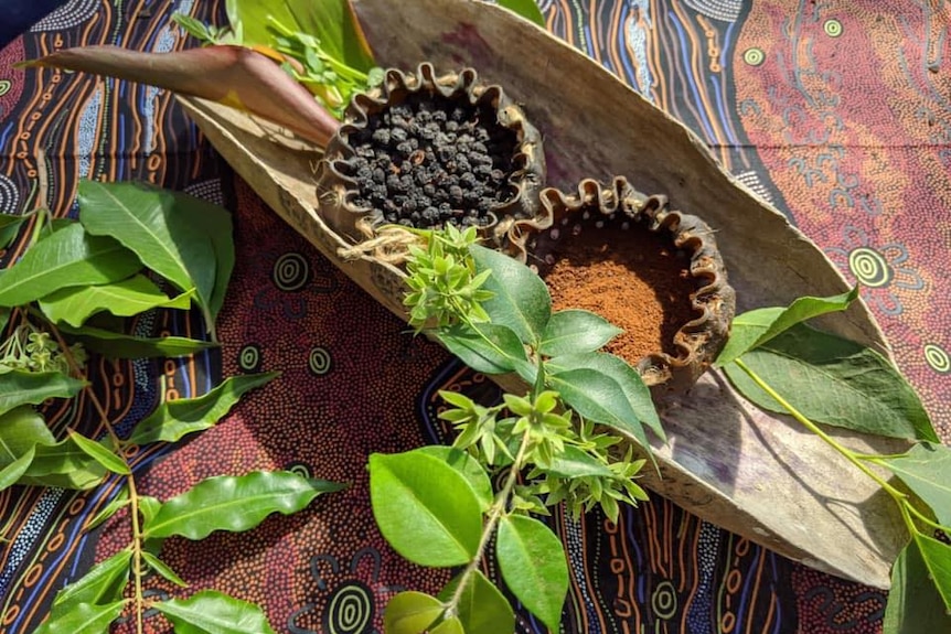 Pepperberries fill a handmade seaweed pouch, next to another pouch with ground pepperberries