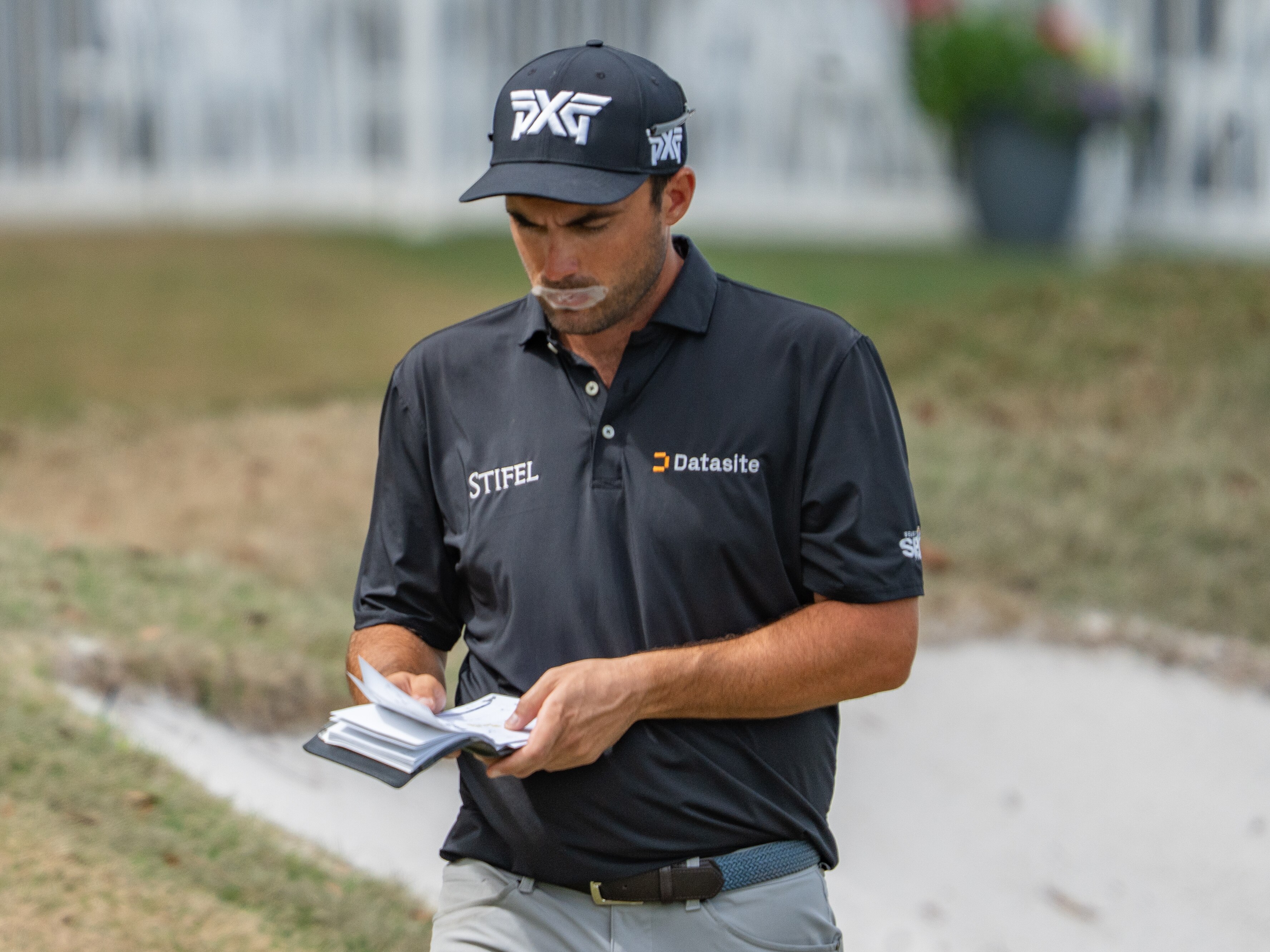 Ryan McCormick wears tape on his butterfly as he checks his score.
