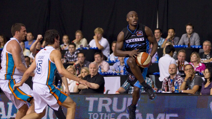 On the run ... Cedric Jackson prepares for launch against the Blaze defence.