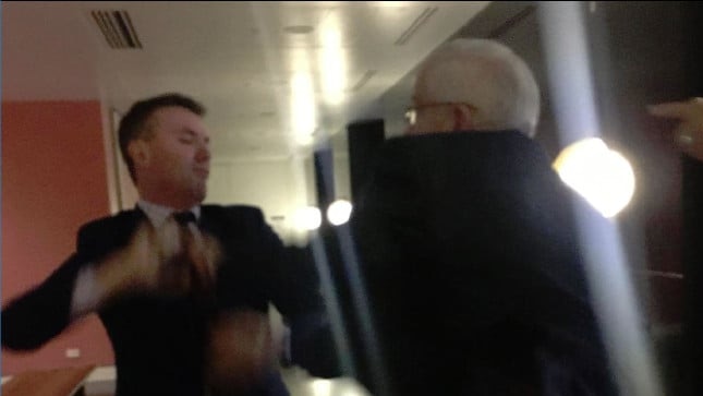 James Ashby and former One Nation senator Brian Burston scuffle in a grainy image.