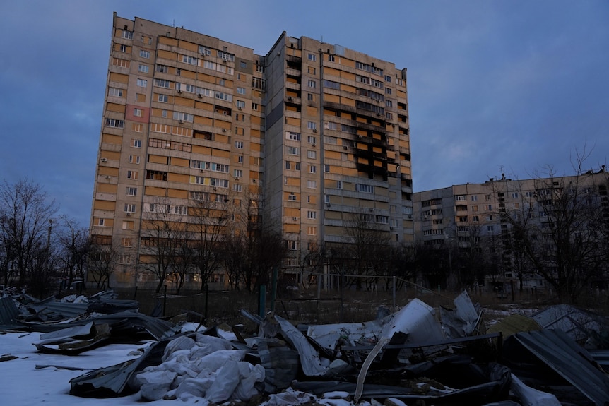 Two strafed buildings at sunset  