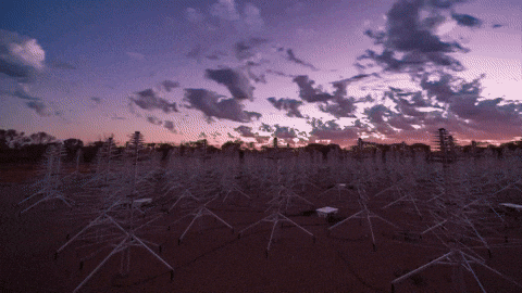 Timelapse of a sky from twilight to night, with antennas scattered across the landscape.