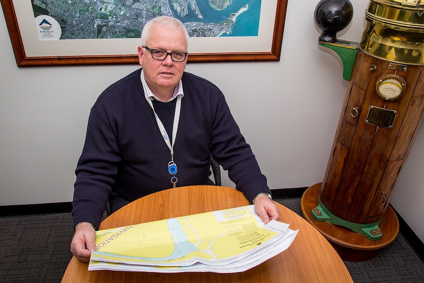 Peter Dwyer looks at a map of the port.