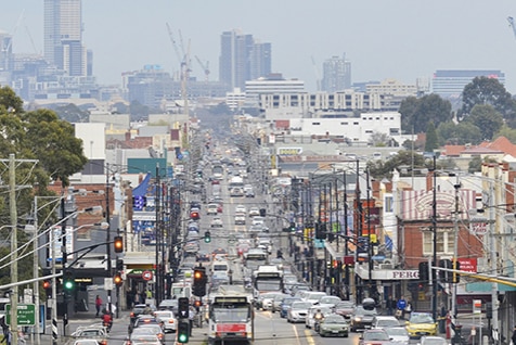 A busy city street with cars and buildings.