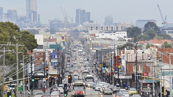 A busy city street with cars and buildings.