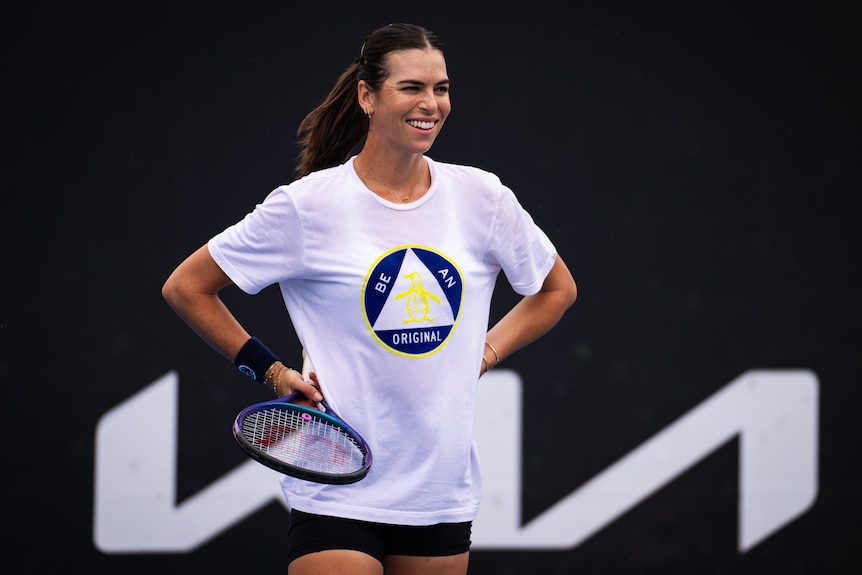 Ajla Tomljanovic smiles with her hands on her hips