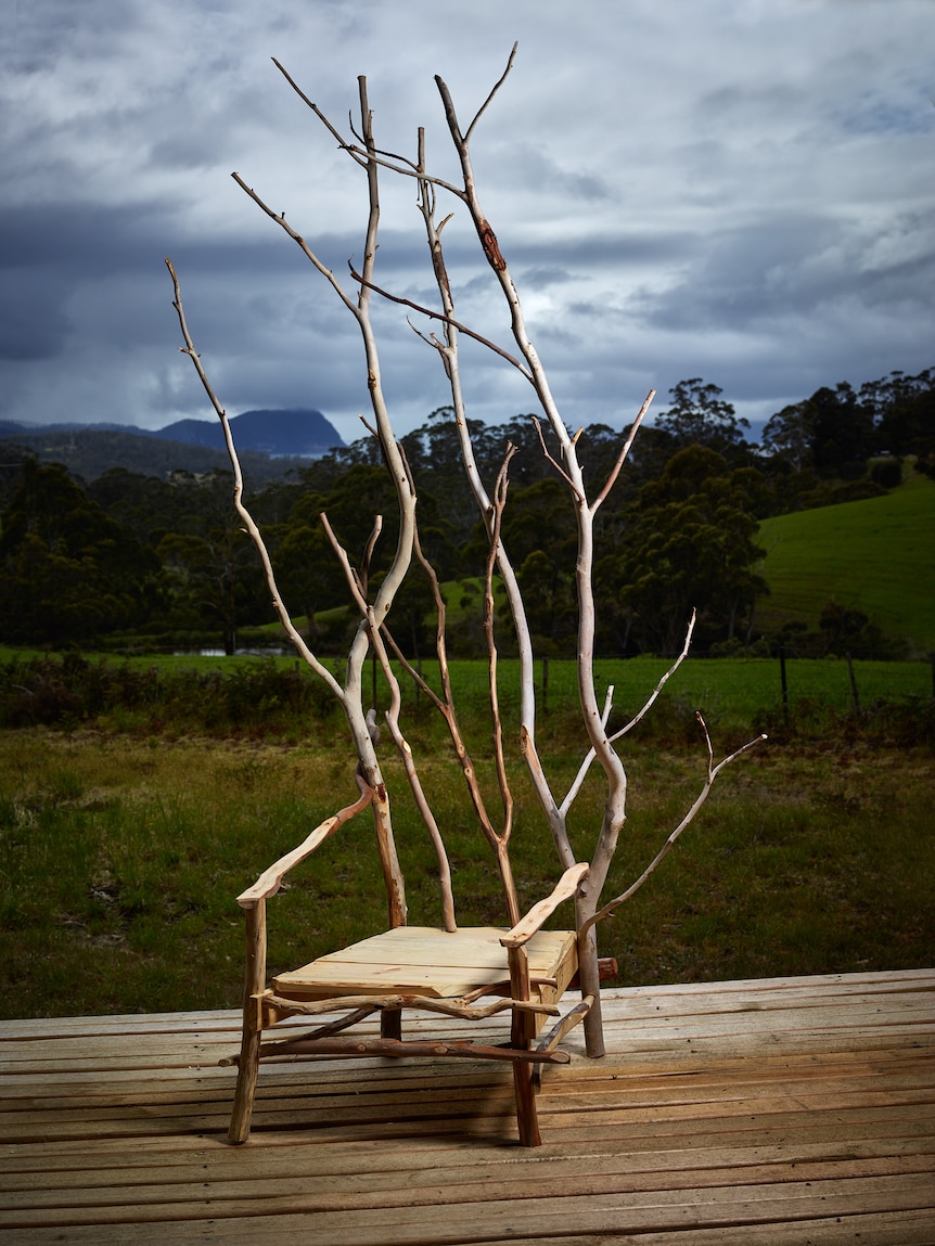 A chair made from scrub with a tall back of sticks