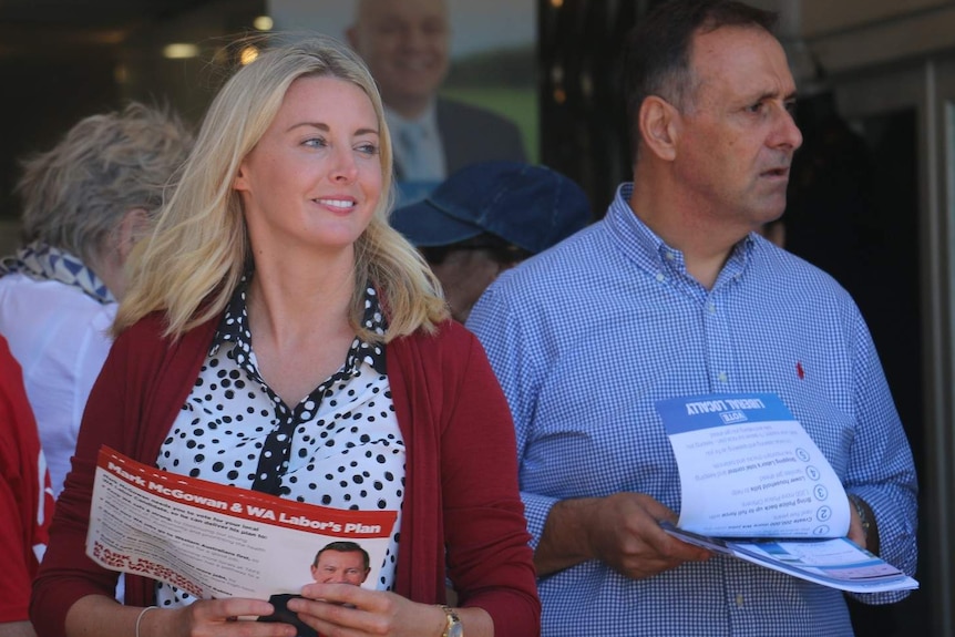 Caitlin Collins and Peter Katsambanis side by side handing out campaign material