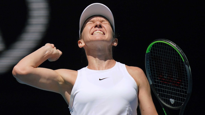 A female tennis player punches the air as she celebrates winning a match at the Australian Open.