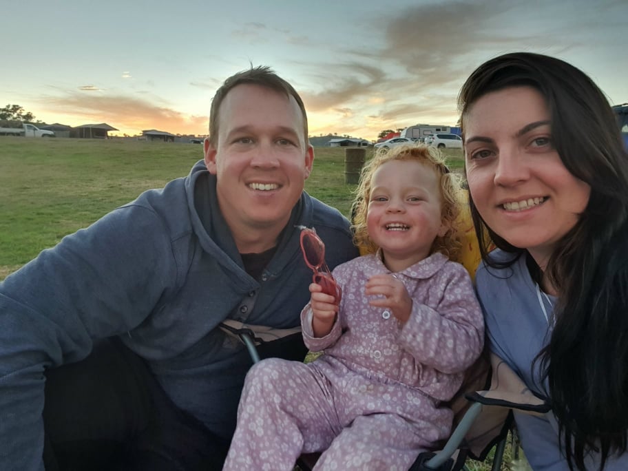 A man and woman with a young girl sitting between them