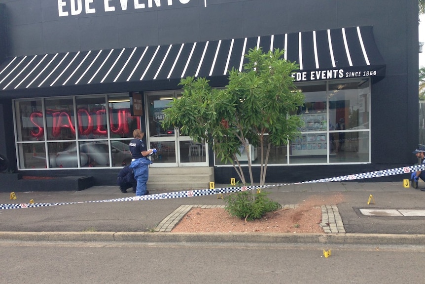 Forensic officers combing through the scene where a 25-year-old man who was shot.