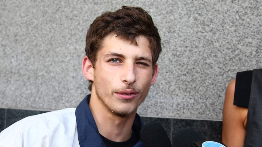 Seventeen year old Abdel Kader Russell-Boumzar leaves the court after being granted bail in Brisbane, Monday, Oct. 13, 2014.