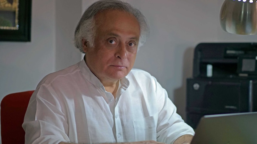 Jairam Ramesh sits at a laptop computer.