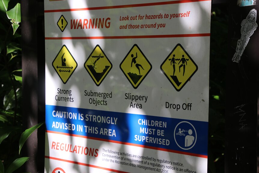 A sign showing hazard information for Crystal Cascades.