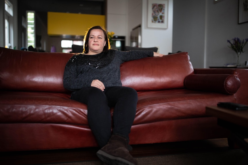 A woman sits on a couch