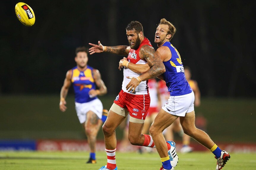 Sydney's Lance Franklin contests the ball with West Coast's Will Schofield.