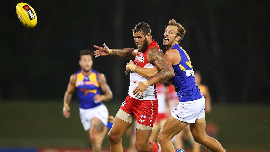 Sydney's Lance Franklin contests the ball with West Coast's Will Schofield.