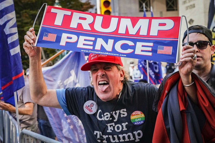 An angry supporter of President Donald Trump shouts at crowds of celebrating demonstrators.